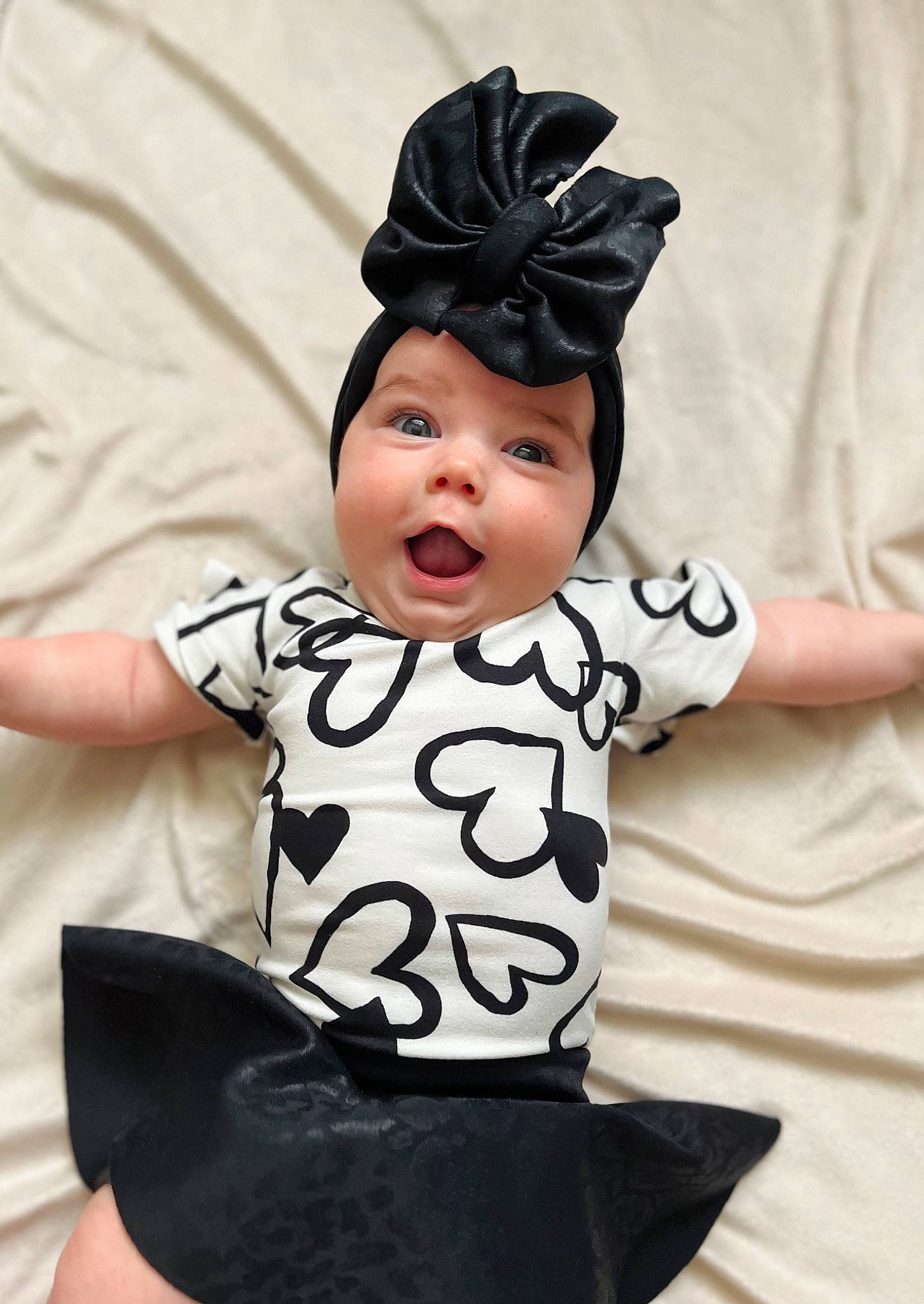 Hadley is registered to the contest to win money with this photo: baby, baby_toddler_clothing, cap, child, costume, costume_accessory, costume_hat, face, fashion_accessory, gesture, hairstyle, happy, hat, head, headwear, pattern, person, sitting, sleeve, surprise