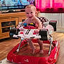 Sebastian joined the competition — help win amazing prizes! baby, child, curtain, floor, foot, furniture, happy, head, indoor, living_room, person, play, red, seat, smiling, television, toy_car, walker, white, wood_floor