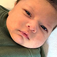 Owen joined the competition — help win amazing prizes! baby, closeup, face, infant, skin, sleepy, pout, green_clothing, newborn, child, soft_light, portrait, cute, resting, indoors, young_child, head, person, baby_face, peaceful