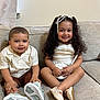 child, children, boy, girl, smiling, sitting, couch, indoor, curly_hair, shorts, shirt, dress, purse, ribbon, footwear, happy, portrait, family, cute, young