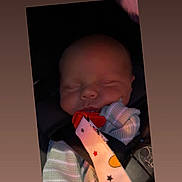 Jayce is registered to the contest to win money with this photo: baby, sleeping, car_seat, pacifier, clip, striped_clothing, infant, child, face, peaceful, seatbelt, safety, indoor, closeup, head, newborn, cute, resting, portrait, soft_lighting