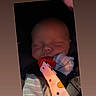 baby, sleeping, car_seat, pacifier, clip, striped_clothing, infant, child, face, peaceful, seatbelt, safety, indoor, closeup, head, newborn, cute, resting, portrait, soft_lighting