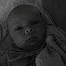 Jayce joined the competition — help win amazing prizes! baby, infant, blanket, pillow, clothing, face, portrait, indoors, cute, child, soft, resting, monochrome, newborn, expression, wrapped, young, sleepwear, lying_down, closeup