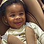 baby, child, smiling, car_seat, seatbelt, curly_hair, infant, cute, happy, portrait, indoors, clothing, straps, face, head, person, safety, seat, cushion, closeup
