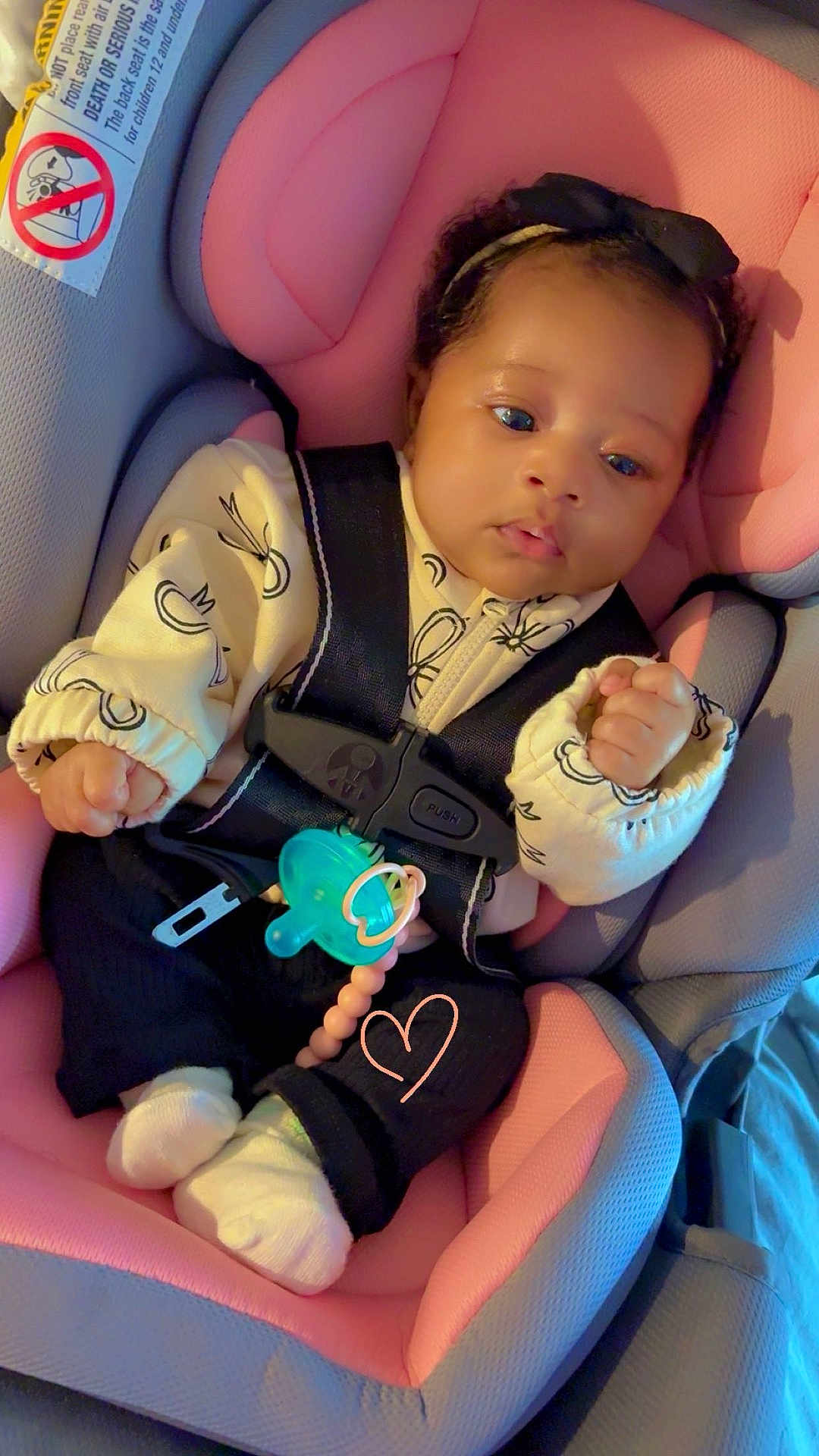 Alaya Rae is registered to the contest to win money with this photo: baby, child, car_seat, pink, gray, headband, pacifier, clothing, infant, cute, face, hands, socks, safety_harness, seatbelt, indoor, portrait, cute_expression, newborn, resting