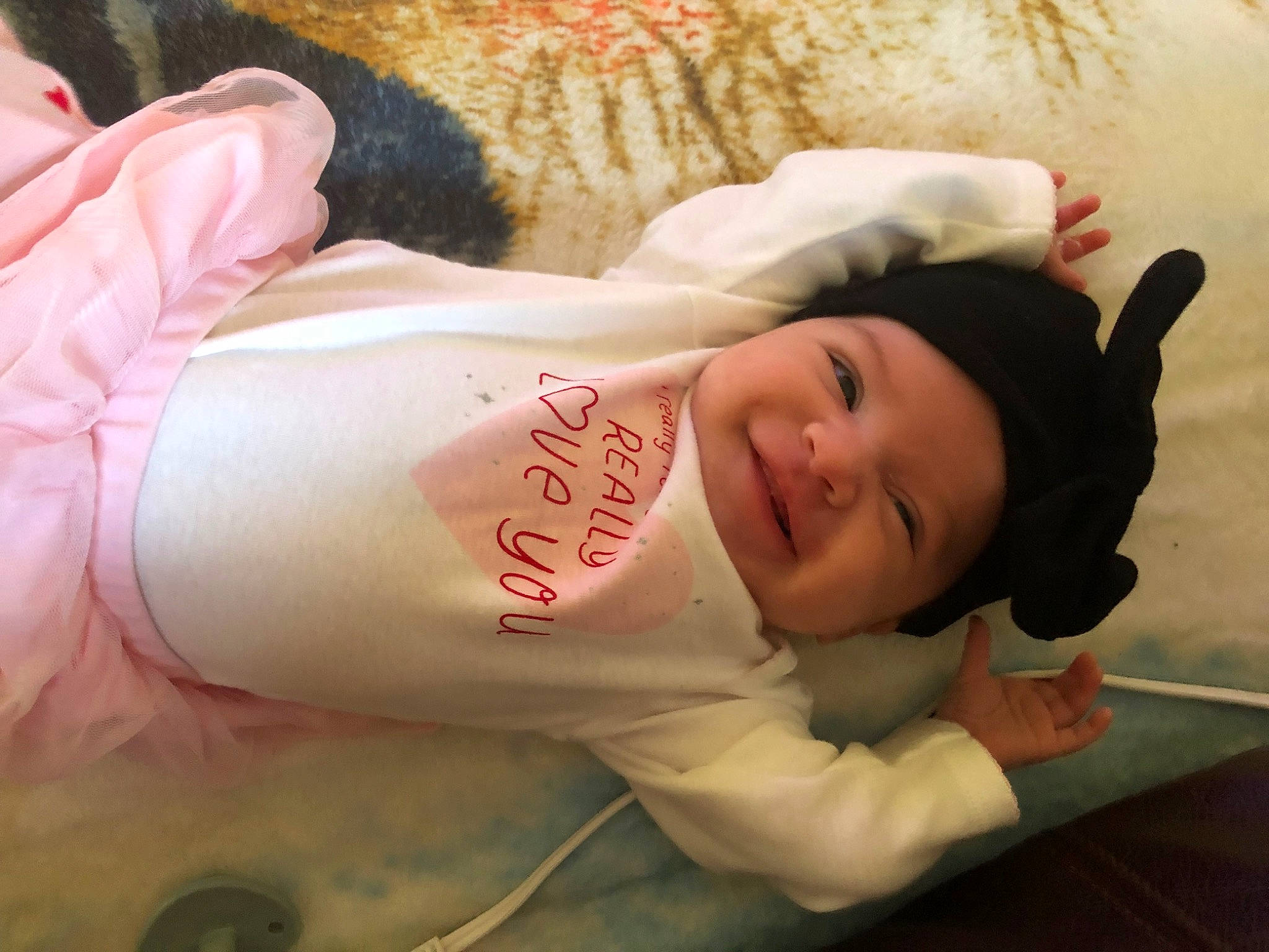 Evie Leigh joined the competition — help win amazing prizes! arm, child, comfort, facial_expression, finger, flash_photography, flooring, fur, hand, happy, head, headwear, human_body, joy, leg, mouth, person, room, skin, sleeve