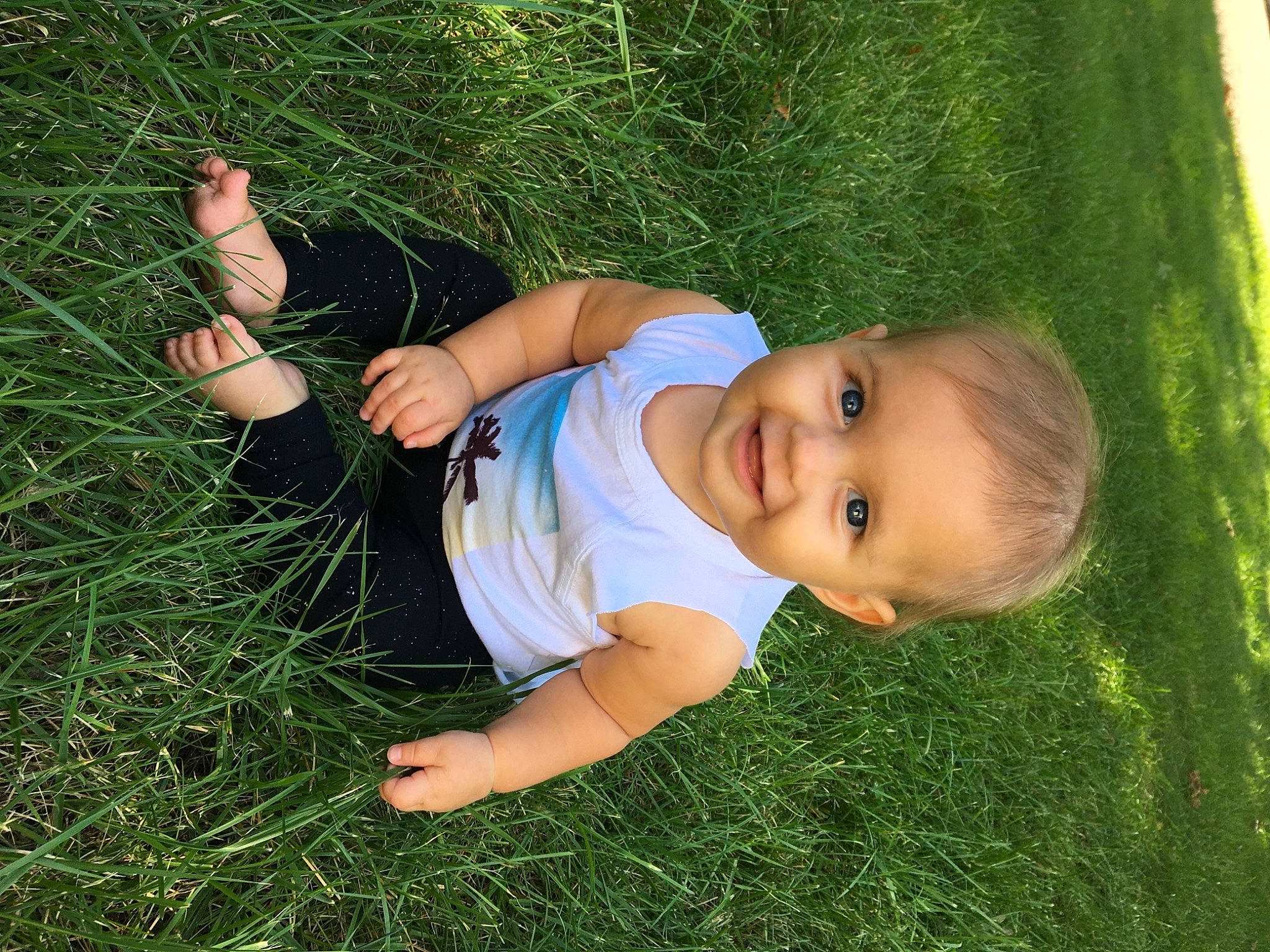 Kenzlee is registered to the contest to win money with this photo: baby_toddler_clothing, eye, face, finger, fun, grass, grassland, happy, human_body, joy, leg, meadow, nose, people_in_nature, person, plant, skin, smile, thumb, toddler