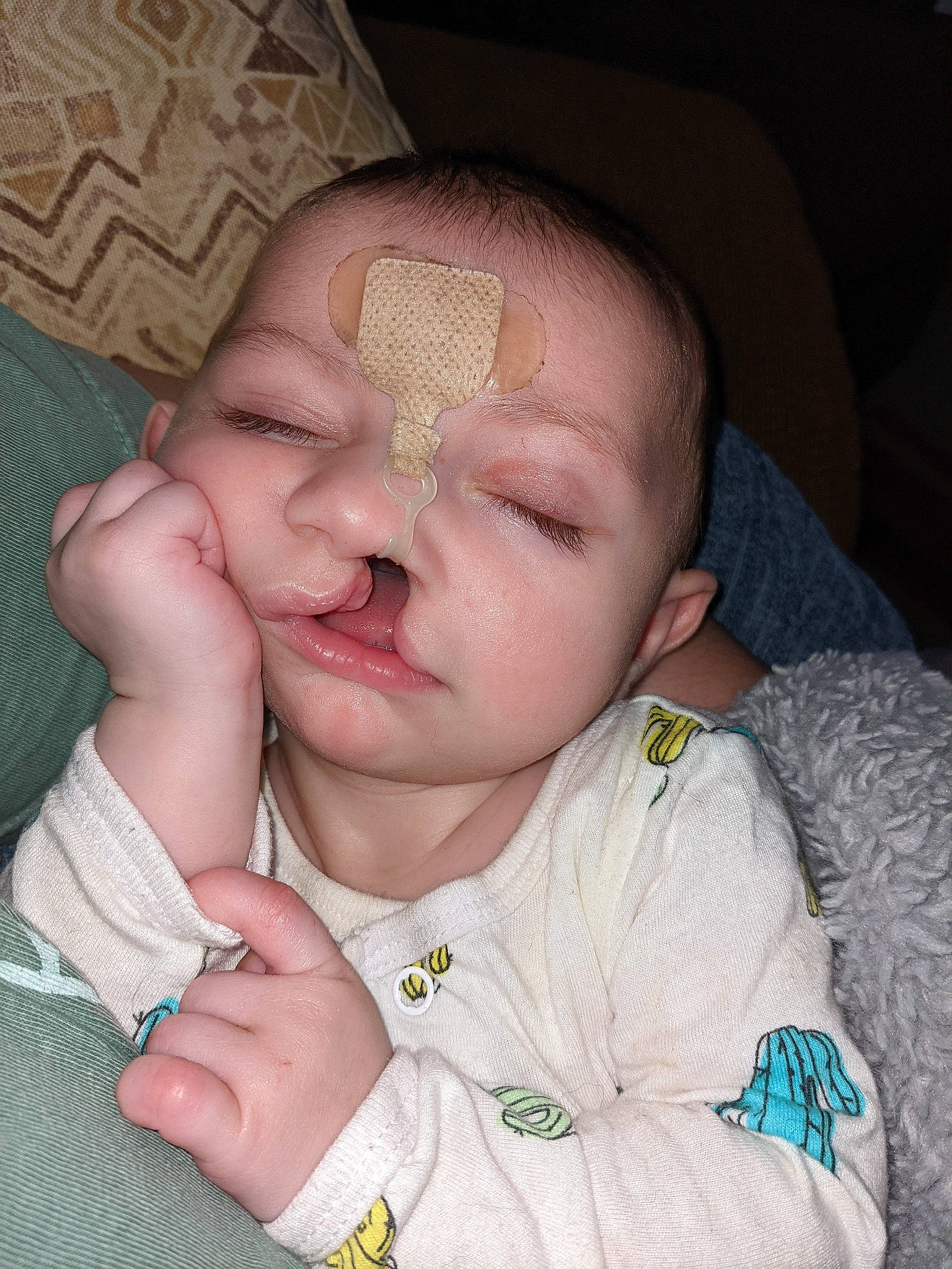 Merlin is registered to the contest to win money with this photo: baby, baby_toddler_clothing, cheek, chin, comfort, ear, eye, eyebrow, eyelash, finger, gesture, head, iris, lip, mouth, nose, person, skin, sleeve, thumb