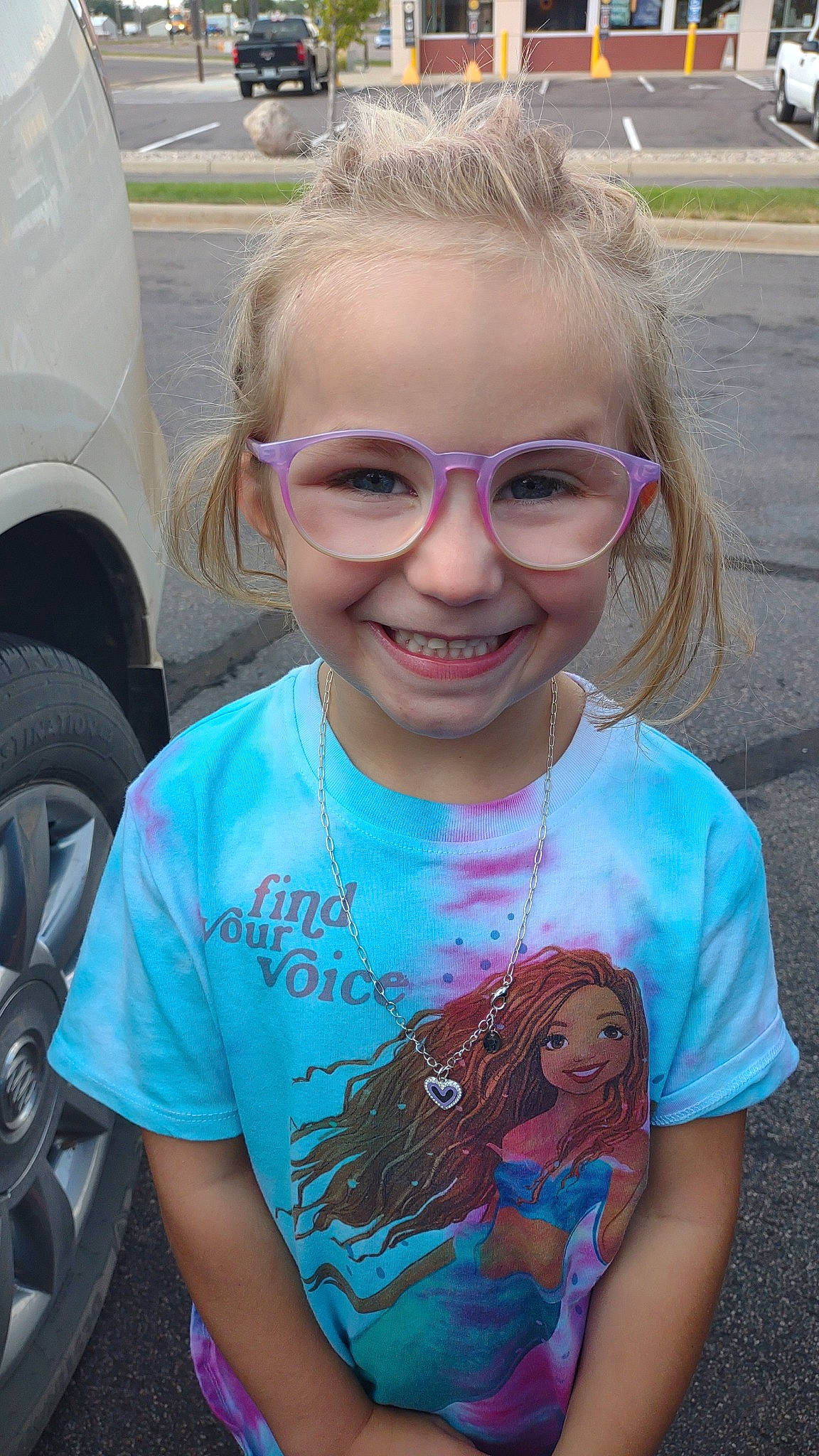Paislee joined the competition — help win amazing prizes! automotive_tire, eye, eyewear, face, facial_expression, goggles, hair, hairstyle, happy, head, joy, lip, mouth, organ, person, skin, sleeve, smile, sunglasses, tire