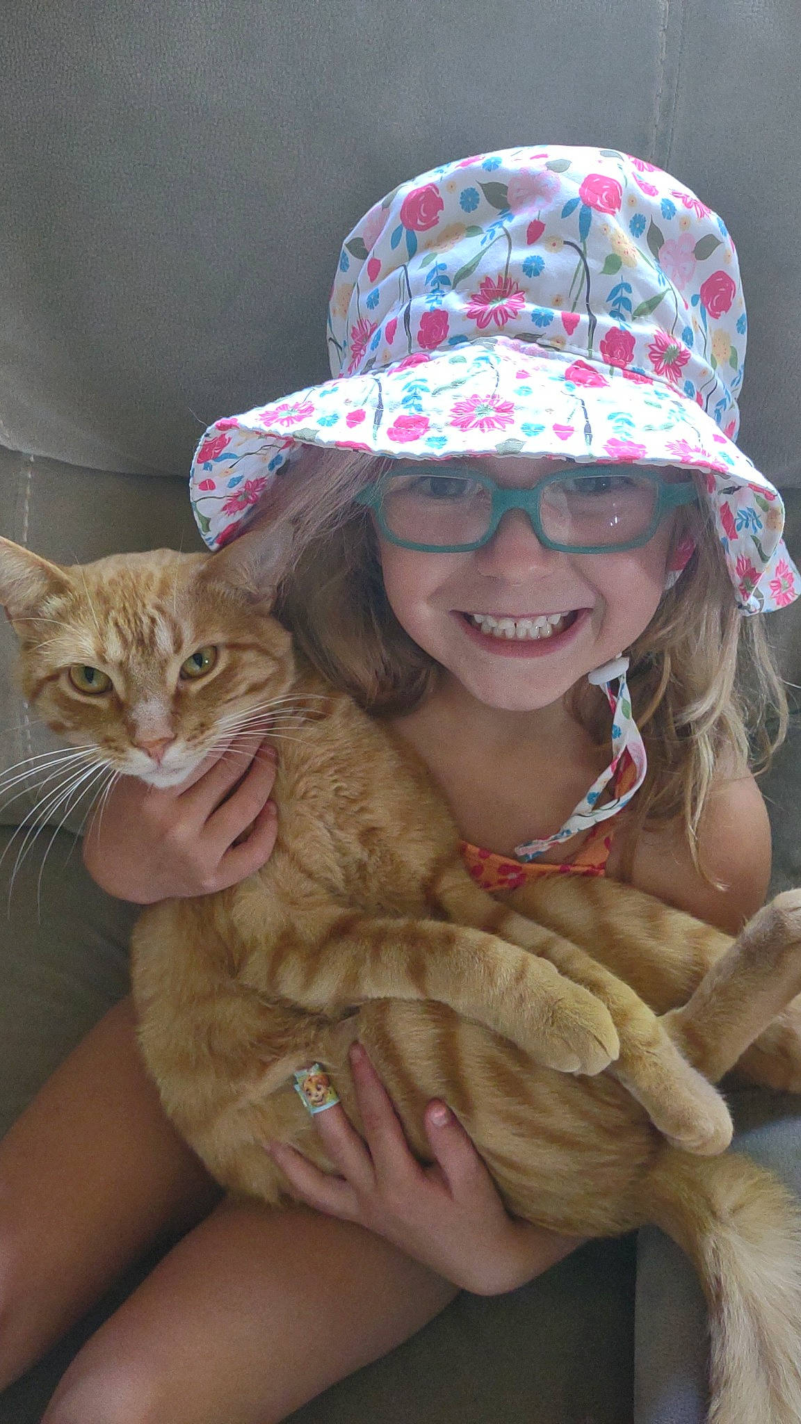 Paislee joined the competition — help win amazing prizes! beauty, carnivore, cat, costume_hat, cowboy_hat, eyewear, facial_expression, fawn, felidae, glasses, hand, happy, hat, joy, mammal, person, skin, small_to_medium_sized_cats, smile, sun_hat