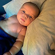 Aviahna joined the competition — help win amazing prizes! arm, baby, bare_chest, blanket, child, comfort, cozy, curious, expression, eyes, face, indoor, infant, lying_down, newborn, person, pillow, resting, skin, soft_light