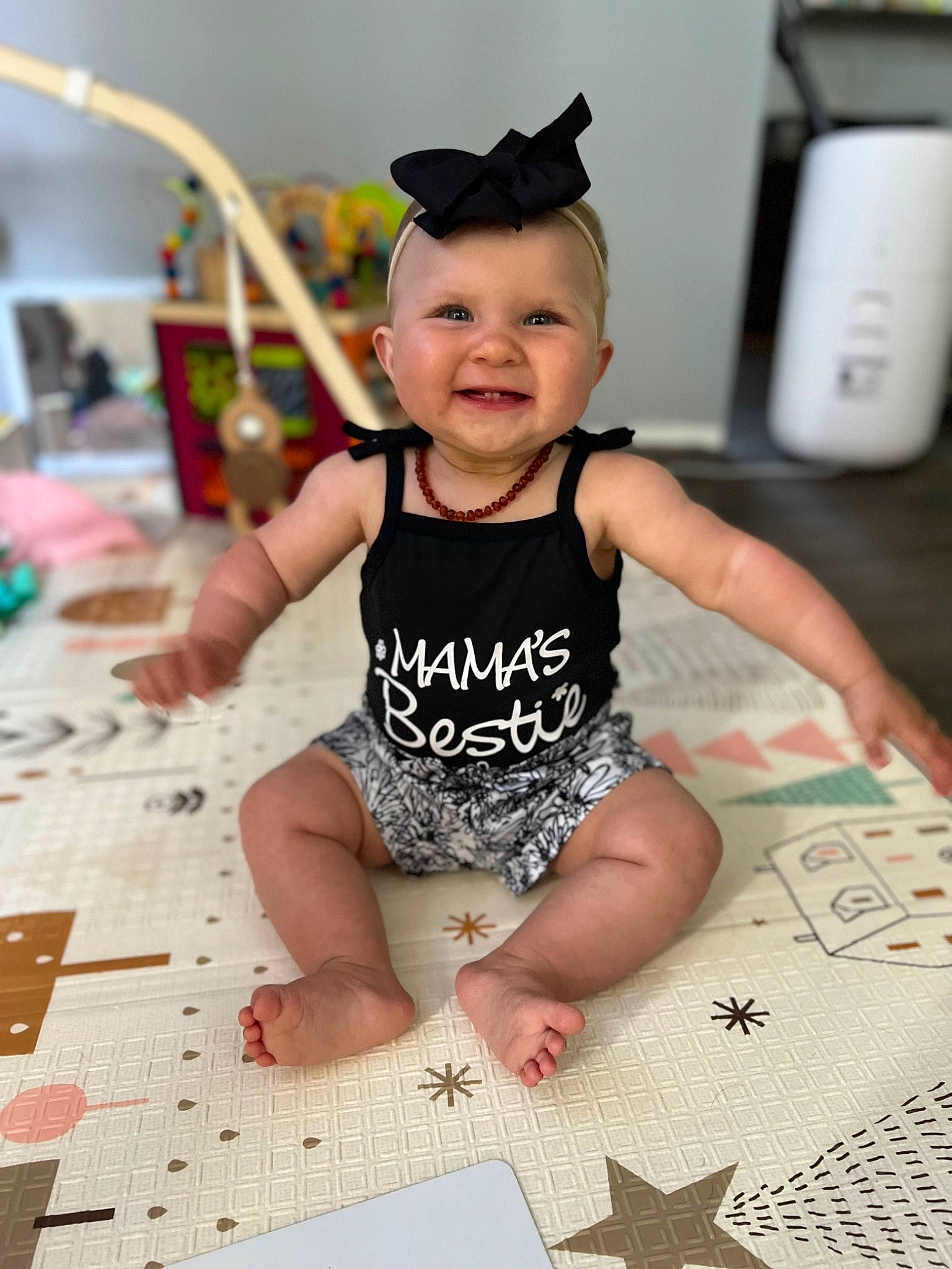 Kensley joined the competition — help win amazing prizes! baby, baby_toddler_clothing, barefoot, child, fashion_accessory, flooring, foot, fun, happy, human_body, human_leg, joy, pattern, person, room, sitting, sleeve, smile, t_shirt, thigh