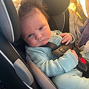 Shiloh is registered to the contest to win money with this photo: baby, car_seat, seatbelt, infant, blue_outfit, hair, face, expression, child, sunlight, indoor, clothing, sitting, hand, headrest, safety, person, portrait, closeup, young