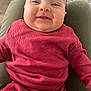 baby, smile, red_clothing, ribbed_texture, face, child, happy, cute, indoor, person, infant, closeup, seated, portrait, skin, head, young_child, warm, comfort, joy