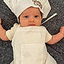 Lydia a rejoint le concours — aidez-le/la à gagner de superbes lots ! baby, infant, chef_hat, apron, white_clothing, carpet, cute, portrait, laying_down, child, face, headwear, soft_texture, indoor, small_child, newborn, adorable, person, looking, expression