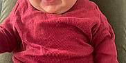 Lydia participe au concours pour gagner de l'argent avec cette photo : baby, child, smiling, red_clothing, ribbed_fabric, person, lap, happy, cute, infant, portrait, indoor, closeup, face, hand, fingers, skin, sitting, joyful, expressive