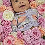 baby, smiling, flower_crown, roses, pink_flowers, white_flowers, purple_flowers, floral_outfit, infant, cute, portrait, closeup, nature, spring, soft_colors, happy, face, child, blossoms, background