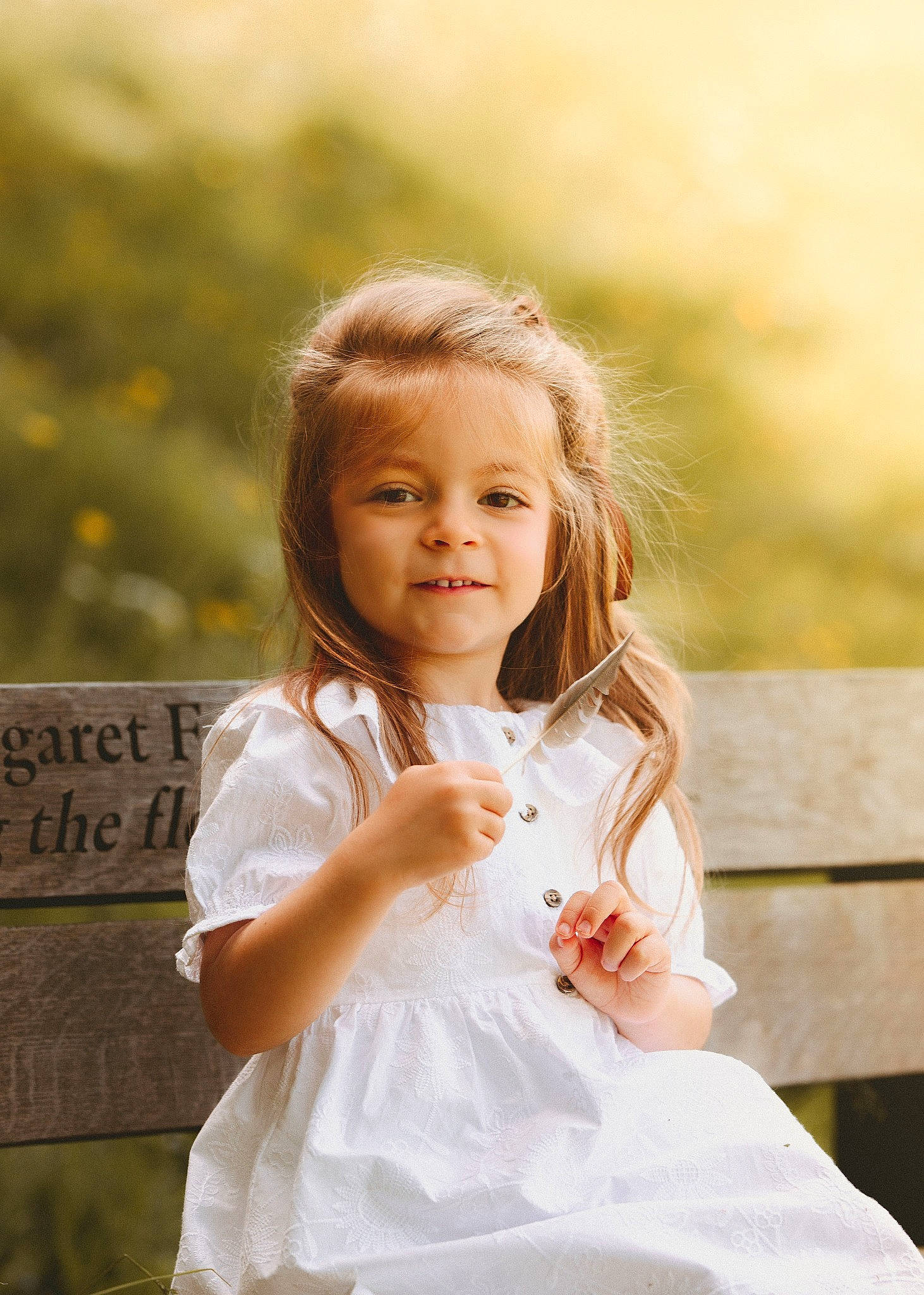 Sarah is registered to the contest to win money with this photo: blond, child, dress, flash_photography, formal_wear, fun, gesture, grass, hairstyle, happy, joy, peach, people_in_nature, person, plant, portrait, portrait_photography, sitting, smile, sunlight