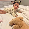 baby, infant, pigtails, hair_bows, onesie, bed, blanket, teddy_bear, pacifier, crawling, nursery, child, smiling, indoor, soft_toy, cute, sleepwear, furniture, happy, portrait