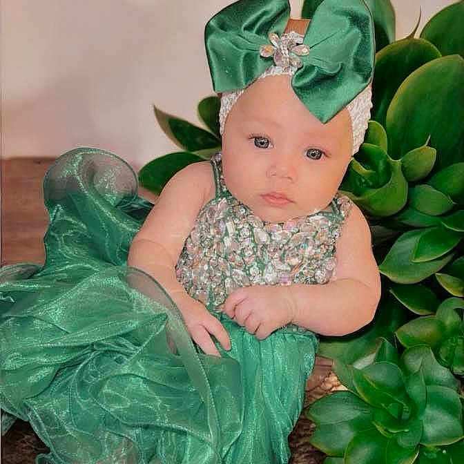 Lainey is registered to the contest to win money with this photo: accessories, baby, bonnet, clothing, costume, dress, face, green, greenhair, hair, hat, head, jewelry, lady, person, photography, portrait, sitting, sleeve, wig
