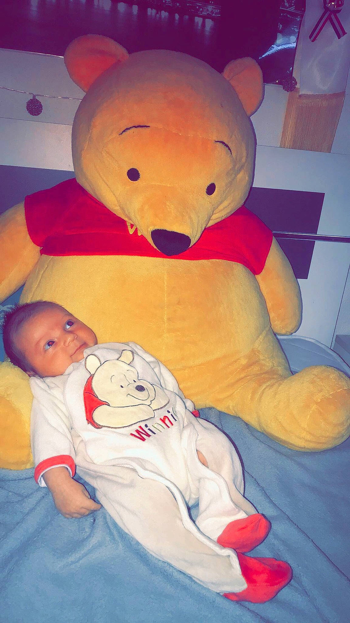 Giovanni a rejoint le concours — aidez-le/la à gagner de superbes lots ! baby, baby_toddler_clothing, bear, child, comfort, fictional_character, fun, happy, lap, linens, nose, orange, person, plush, room, sitting, stuffed_toy, teddy_bear, textile, toddler