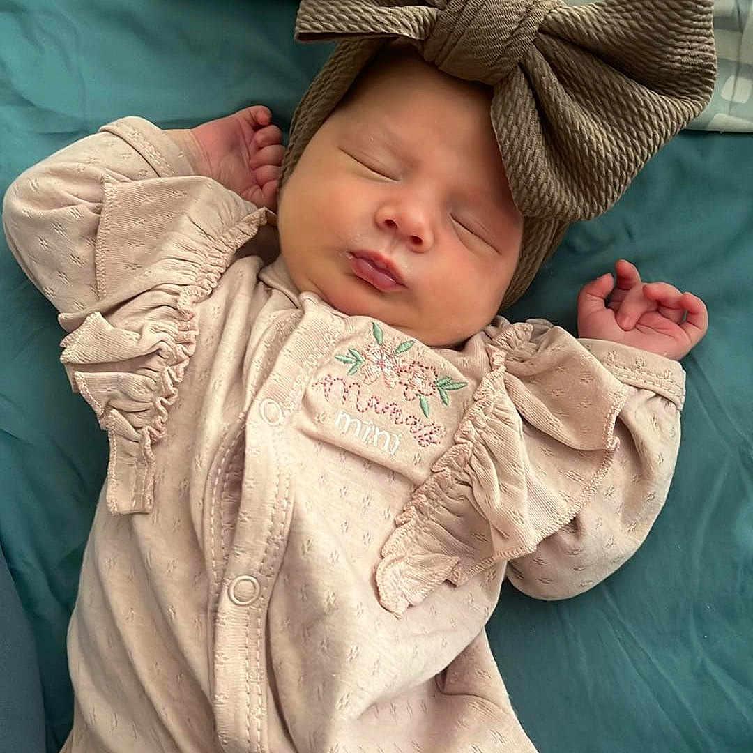 Aurora is registered to the contest to win money with this photo: baby, bed, blanket, bonnet, clothing, cushion, face, furniture, glove, hat, head, homedecor, newborn, person, photography, portrait, quilt, scarf, sleeping, yawning