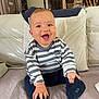 baby, child, clothing, couch, cozy, cushion, cute, furniture, happy, home, indoor, infant, person, playful, portrait, sitting, smiling, sock, striped_shirt, young_child