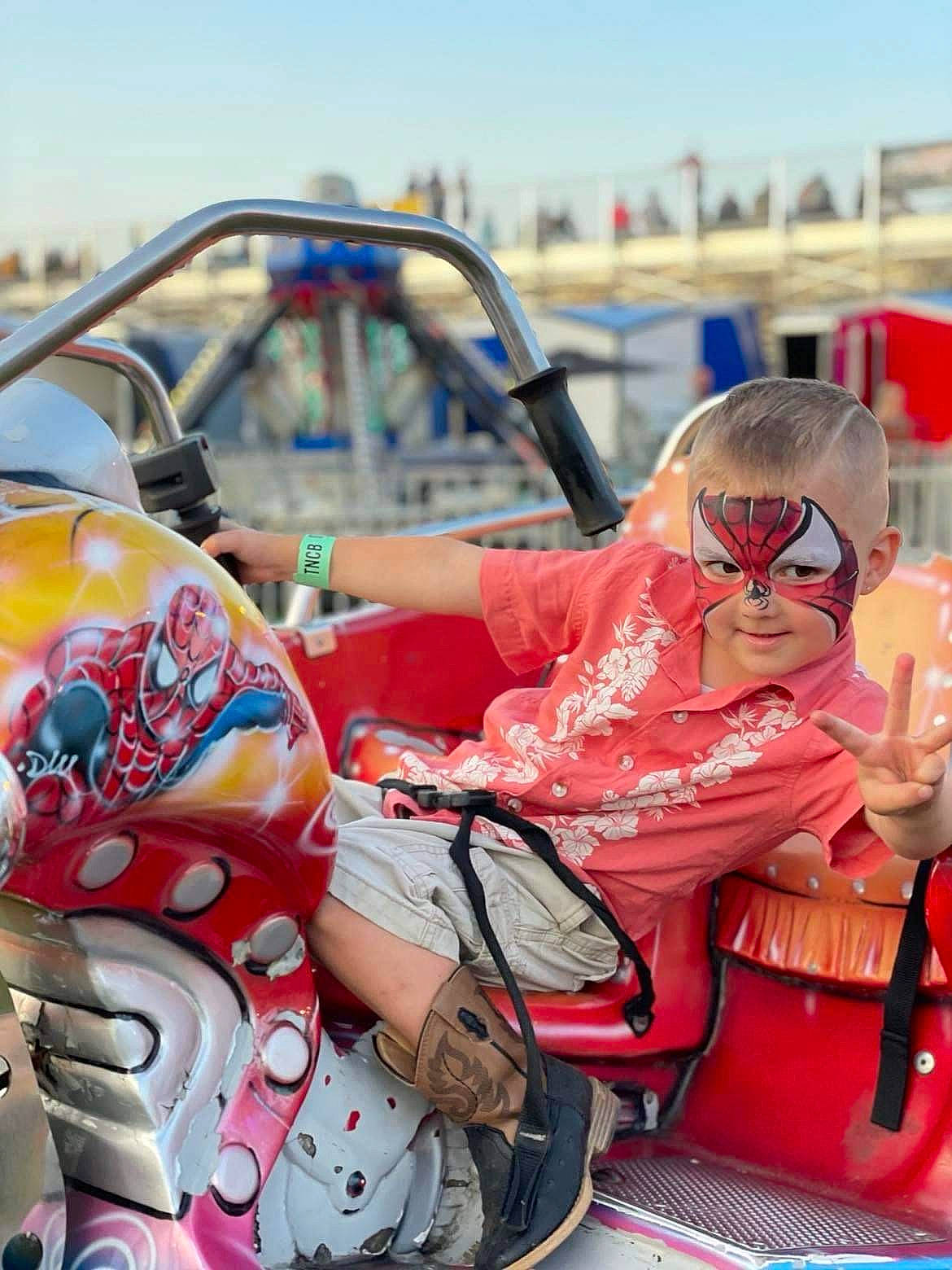 Preston is registered to the contest to win money with this photo: automotive_design, automotive_exterior, automotive_wheel_system, carmine, child, event, eyewear, festival, fun, leisure, luggage_and_bags, motor_vehicle, person, personal_protective_equipment, public_event, recreation, sitting, sky, tourism, toy