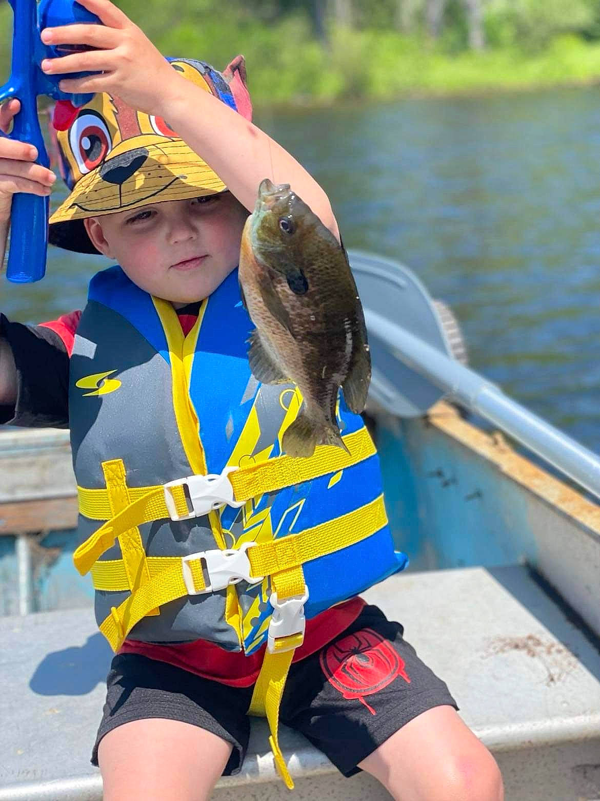 Preston is registered to the contest to win money with this photo: blue, boat, boats_and_boating_equipment_and_supplies, electric_blue, event, eyewear, fun, headwear, lake, leisure, person, personal_protective_equipment, recreation, sports, sports_uniform, sportswear, team, thigh, tree, uniform