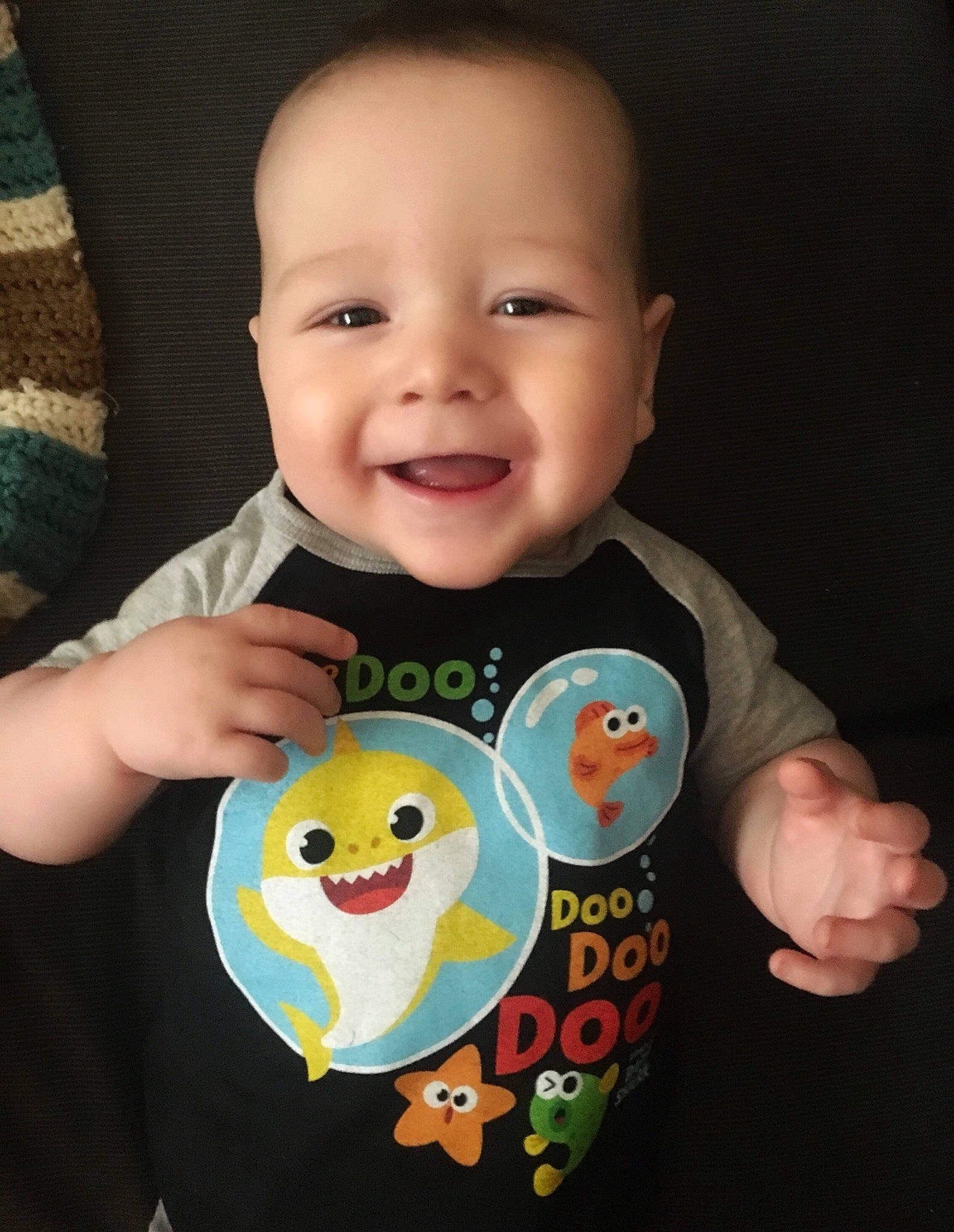 Maximus is registered to the contest to win money with this photo: baby, baby_products, baby_toddler_clothing, bib, cheek, child, cool, eye, face, facial_expression, finger, forehead, head, mouth, nose, person, product, sleeve, smile, t_shirt