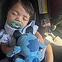 baby, sleeping, pacifier, car_seat, stuffed_toy, blue, child, infant, seatbelt, clothing, peaceful, indoors, cute, young, toy, comfort, relaxation, portrait, closeup, soft_light