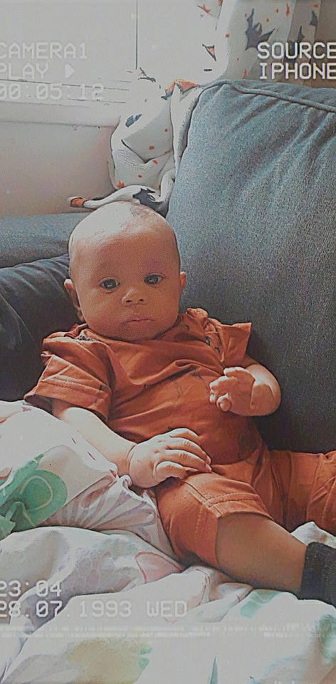 Malachi is registered to the contest to win money with this photo: abdomen, baby, baby_products, baby_toddler_clothing, car_seat, cheek, child, comfort, hat, human_leg, lap, linens, person, pillow, room, sitting, skin, thigh, thumb, toddler