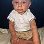 toddler, child, boy, sitting, indoor, blanket, couch, clothing, shorts, polo_shirt, barefoot, face, blue_eyes, skin, hand, foot, expressionless, young, portrait, casual