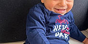 Lyvio a rejoint le concours — aidez-le/la à gagner de superbes lots ! toddler, child, smiling, blue_clothing, couch, indoor, happy, portrait, person, sitting, baby, face, human, casual, cute, playful, young_child, long_sleeve, pants, home
