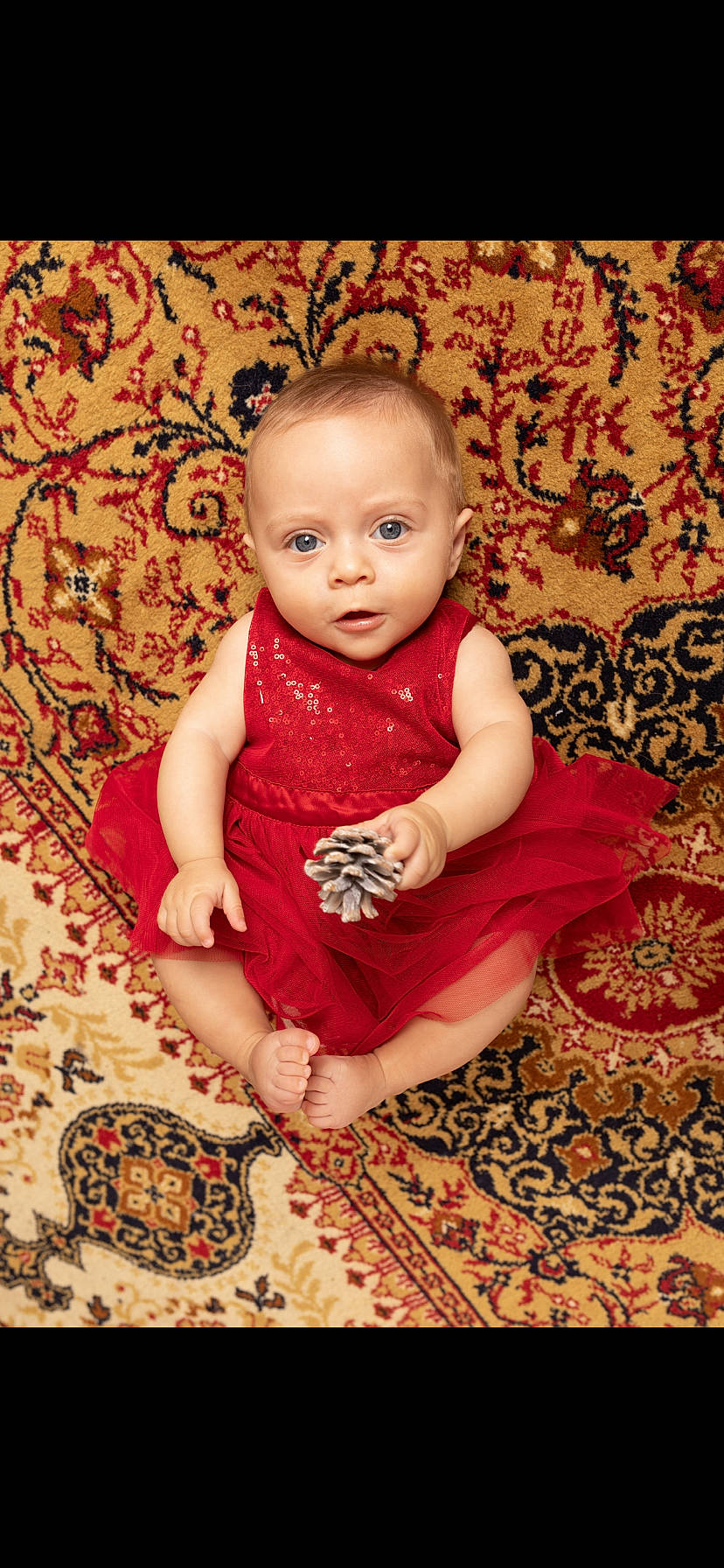 Louna participe au concours pour gagner de l'argent avec cette photo : baby, baby_toddler_clothing, cheek, child, dress, eye, face, finger, flash_photography, floor, flooring, happy, magenta, pattern, person, pink, skin, smile, textile, toddler
