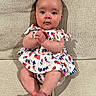 Maya is registered to the contest to win money with this photo: baby, infant, child, sitting, couch, beige, clothing, usa_theme, dress, face, hands, feet, indoors, portrait, cute, expression, skin, person, young, comfortable