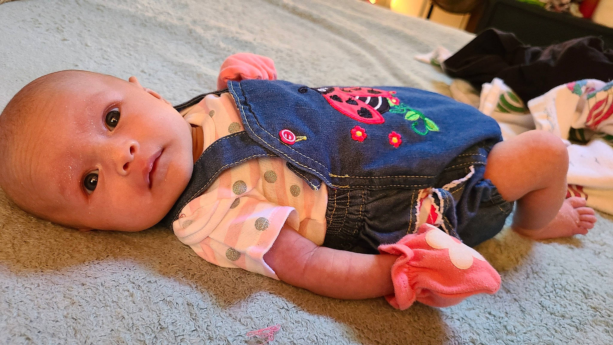 Meekz is registered to the contest to win money with this photo: baby, baby_toddler_clothing, carmine, cheek, child, comfort, fashion_accessory, fun, happy, human_leg, leisure, linens, mouth, nail, orange, pattern, person, sitting, skin, toddler