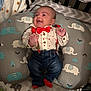 Malakaii is registered to the contest to win money with this photo: baby, infant, smiling, clothing, bow_tie, suspenders, elephant_pattern, pillow, crib, blanket, jeans, socks, happy, indoor, cute, child, face, person, baby_boy, comfortable
