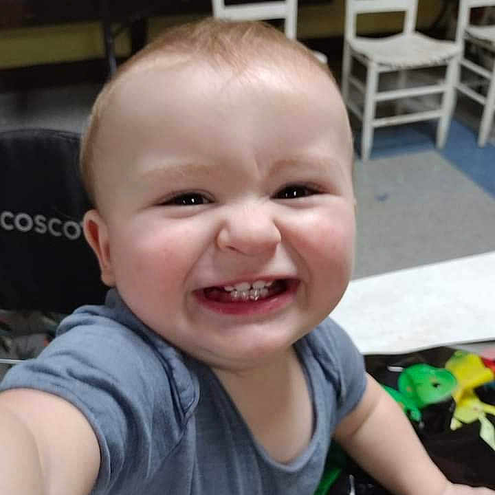 Watson is registered to the contest to win money with this photo: baby, babylaughing, bodypart, chair, clothing, diningtable, face, furniture, happy, head, indoors, laughing, mouth, person, photography, portrait, smile, t_shirt, table, teeth