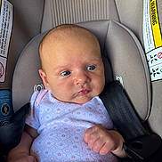Gracelynn Leigh is registered to the contest to win money with this photo: baby, infant, car_seat, blue_eyes, onesie, straps, safety, child, cute, face, head, skin, hands, seatbelt, indoors, newborn, expression, clothing, person, portrait