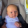 baby, infant, car_seat, blue_eyes, onesie, straps, safety, child, cute, face, head, skin, hands, seatbelt, indoors, newborn, expression, clothing, person, portrait