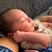 Sebastian is registered to the contest to win money with this photo: baby, sleeping, infant, arm, clothing, person, face, skin, hand, peaceful, rest, closeup, indoor, cute, newborn, soft, comfort, portrait, relaxation, toddler