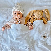 Adriana a rejoint le concours — aidez-le/la à gagner de superbes lots ! adorable, baby, bed, blanket, bunny, child, comfort, cute, indoor, infant, knit_hat, peaceful, plush_toy, resting, sleepwear, soft_texture, sweater, toy, tucked_in, warm