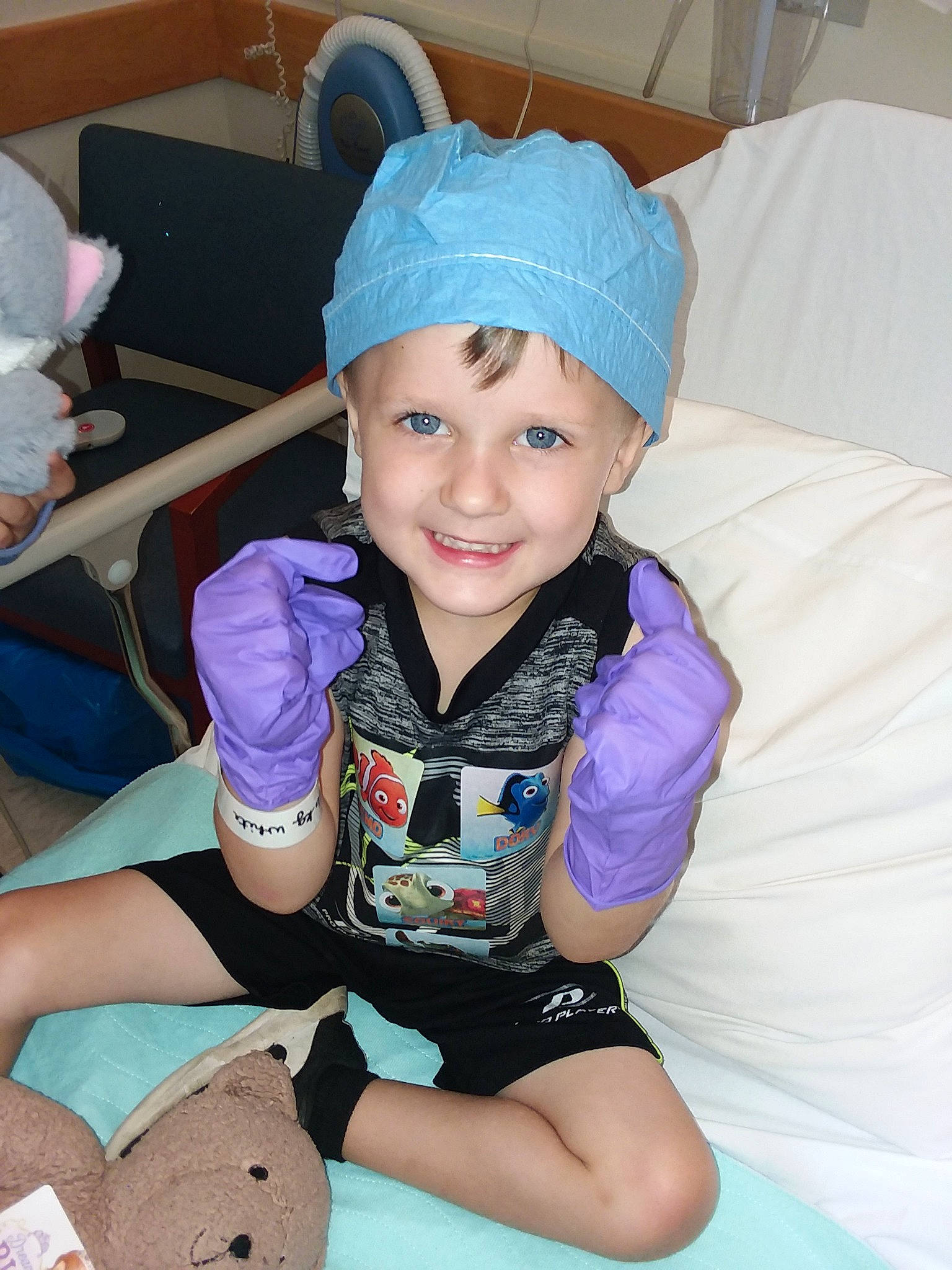 Trevor joined the competition — help win amazing prizes! arm, beanie, bonnet, cap, child, clothing, ear, eye, fashion_accessory, head, headgear, human_body, joy, knit_cap, leg, neck, person, purple, sitting, smile