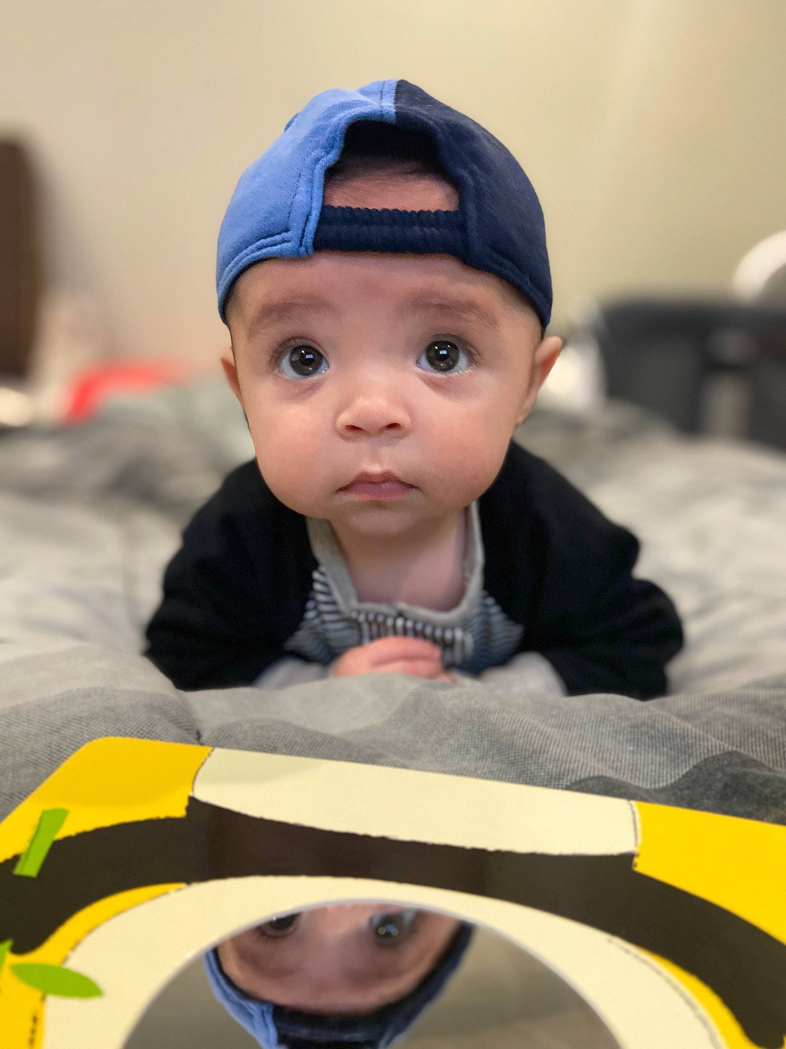 Addison is registered to the contest to win money with this photo: baby, cap, child, chin, close_up, cool, event, eye, eyebrow, facial_expression, forehead, fun, happy, head, headwear, person, personal_protective_equipment, recreation, sitting, skin