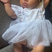Aamiri joined the competition — help win amazing prizes! baby, infant, sleeping, portrait, dress, bow, headband, pink, white, floral, socks, couch, indoor, sitting, peaceful, cute, face, hands, legs, fashion