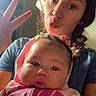 baby, child, siblings, portrait, selfie, smiling, kissy_face, peace_sign, pink_clothing, hair_bow, braided_hair, indoors, sunlight, window, family, infant, sister, close_up, casual, photography