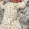 Aamiri is registered to the contest to win money with this photo: newborn, baby, infant, sleeping, portrait, face, floral_outfit, headband, bow, onesie, blanket, gray_blanket, lying_down, indoors, cozy, peaceful, cute, fashion, hands, family_photo