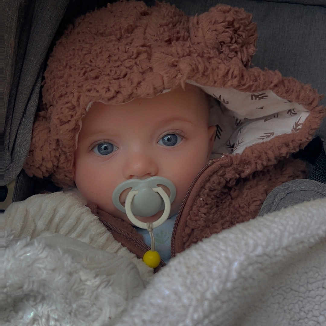 Leviacus is registered to the contest to win money with this photo: baby, blanket, blue_eyes, bundle, child, closeup, comfort, cozy, cute, face, hood, indoor, infant, pacifier, portrait, sleepy, snuggled, soft_texture, warm_clothing, winter_wear
