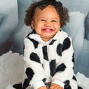 Amelia joined the competition — help win amazing prizes! baby, background, basket, black_and_white, black_bow, child, clothing, curly_hair, cute, face, fashion, hands, happy, indoor, jacket, portrait, sitting, smile, toddler, warm